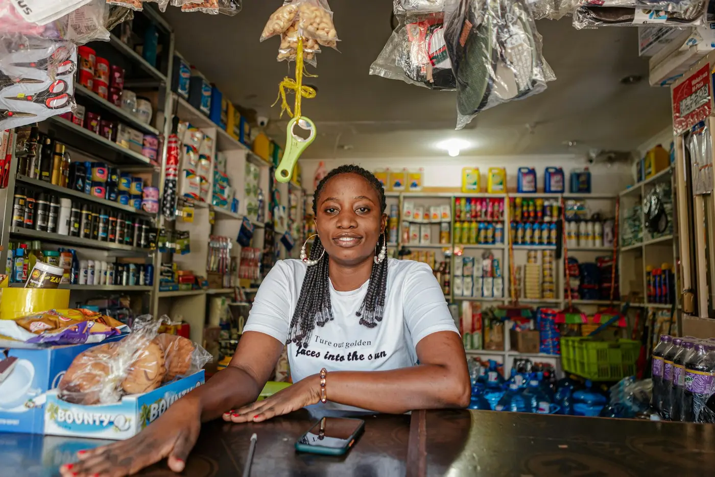 A shopkeeper smiling behind her counter